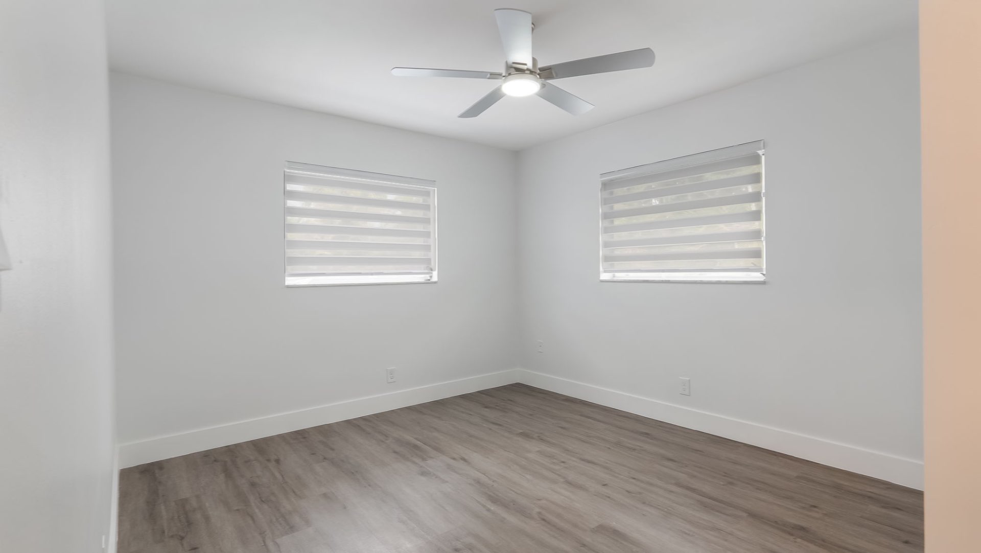Second bedroom with wood floors and dual windows