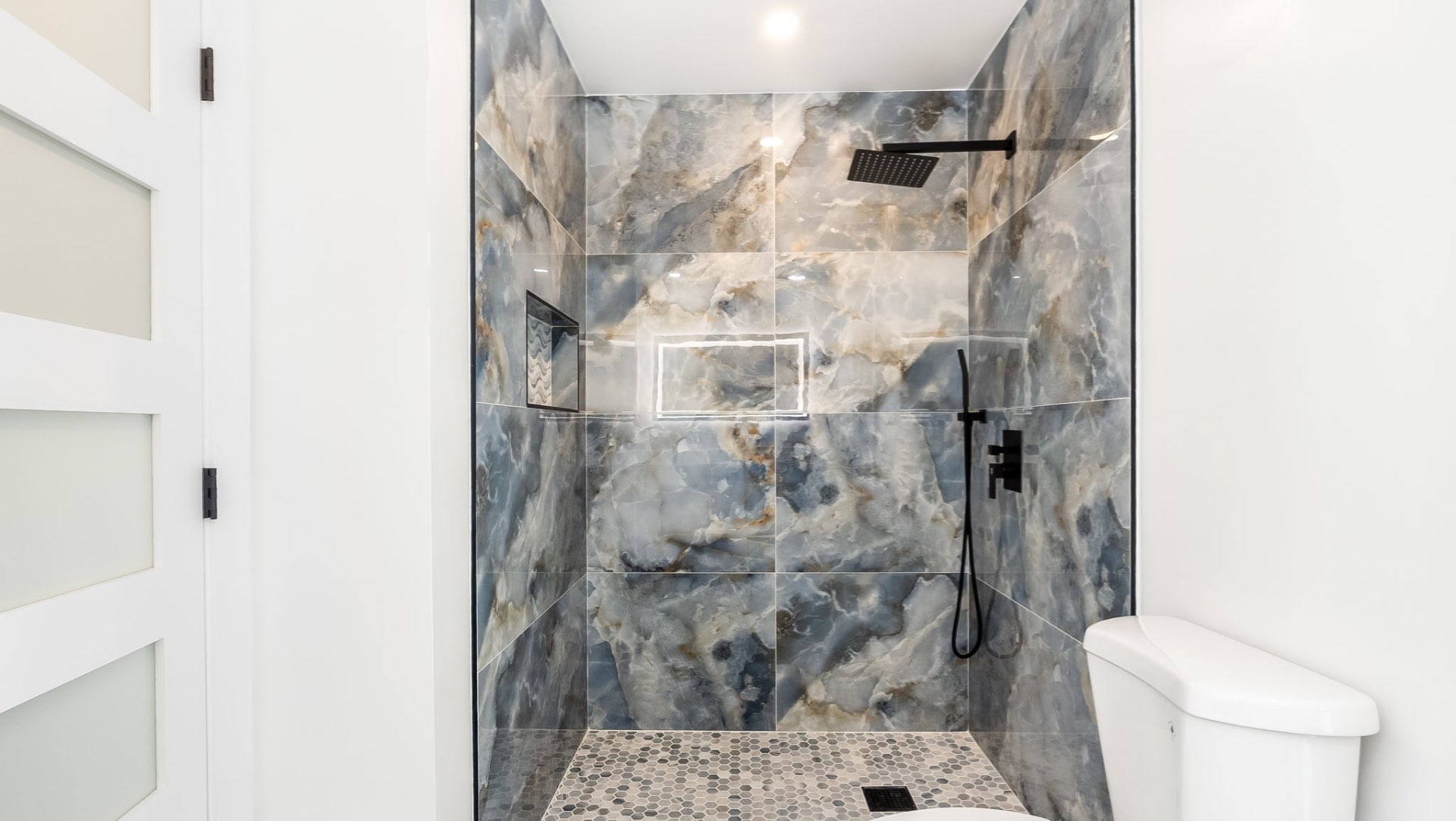 Walk-in shower with blue marble tile