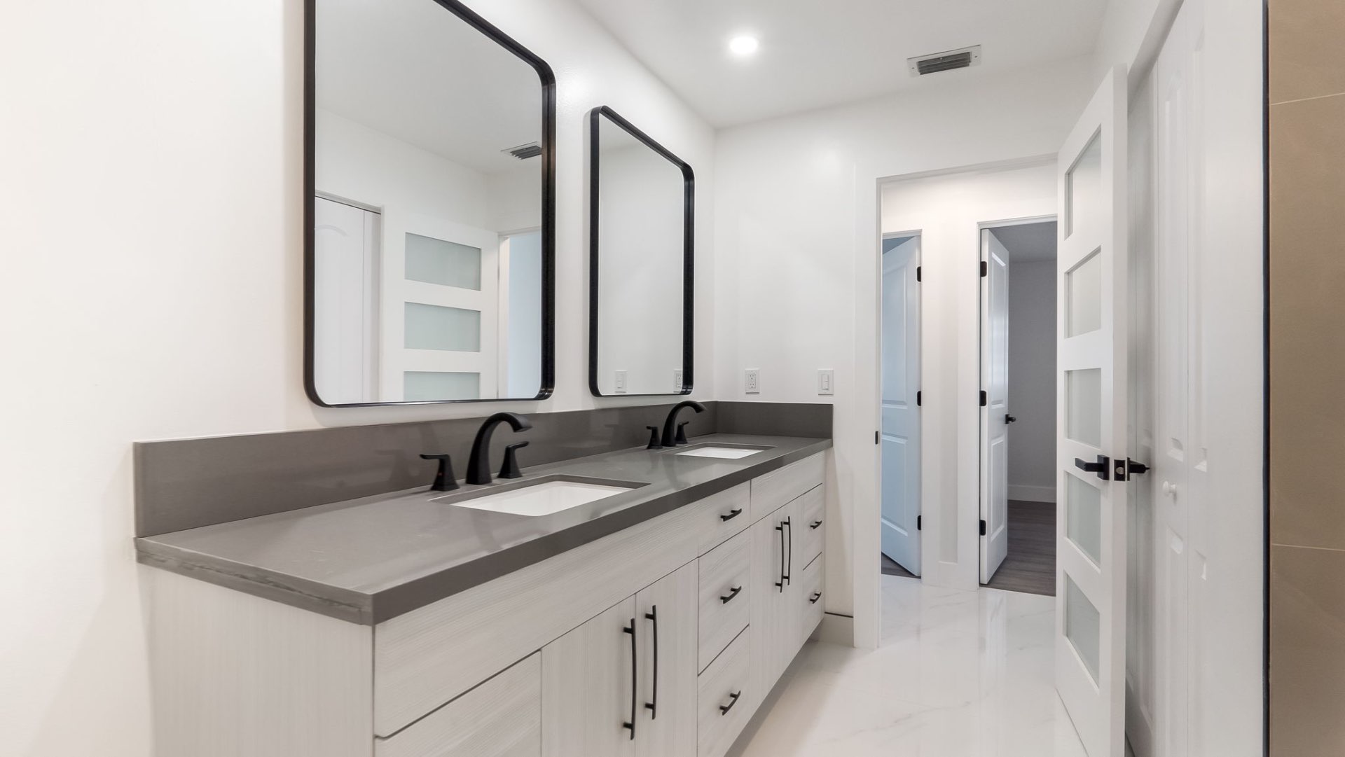 Bathroom with dual vanity and black fixtures