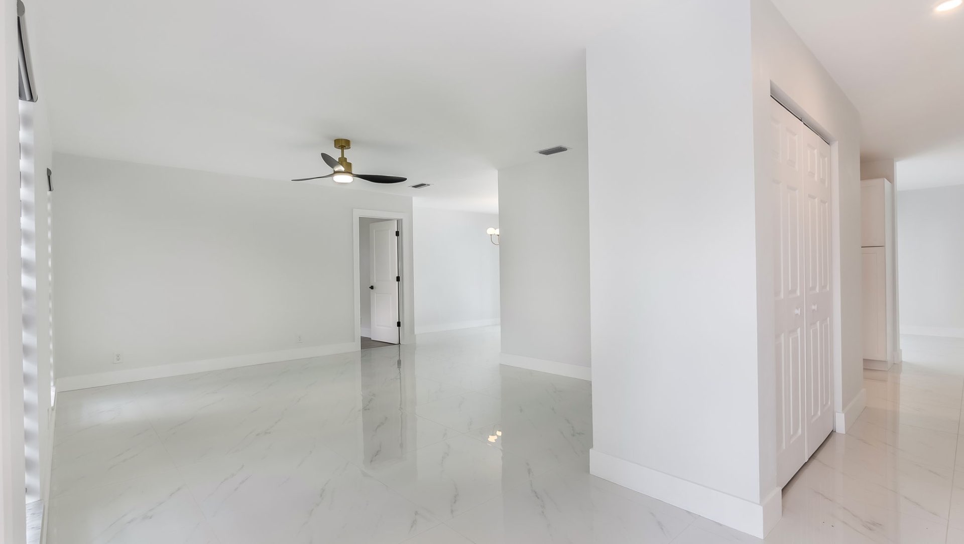 Open-concept living area with marble floors