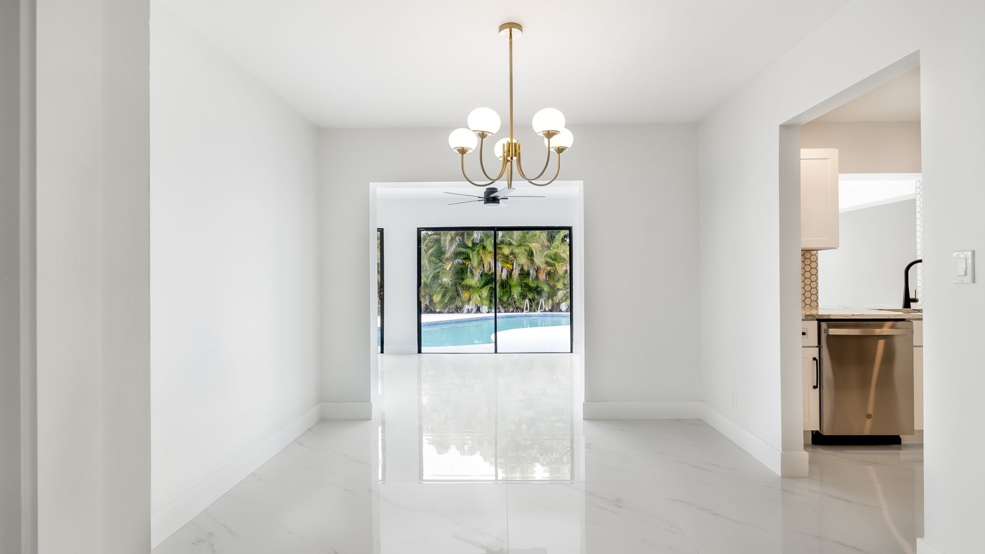 Dining area with chandelier and pool view