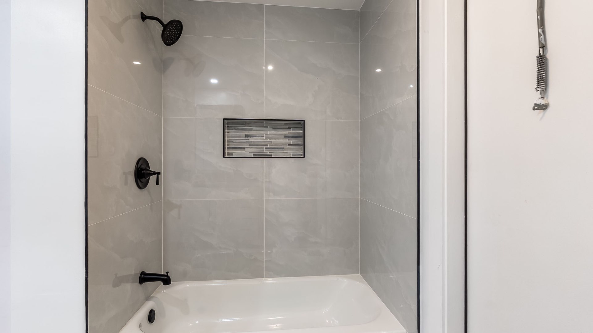 Guest bath with marble tile shower and tub